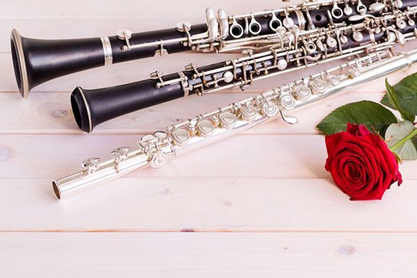 Three wind instruments and a rose