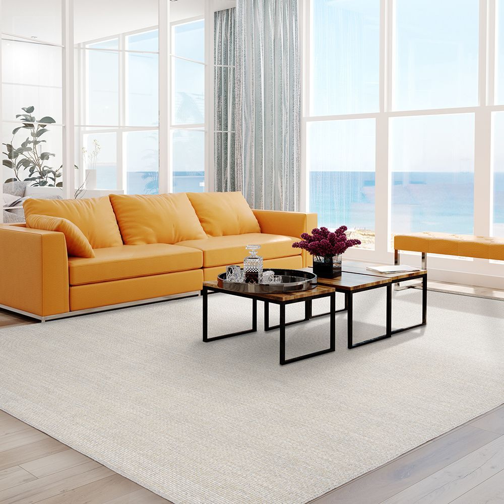 A living room with an orange couch and two coffee tables