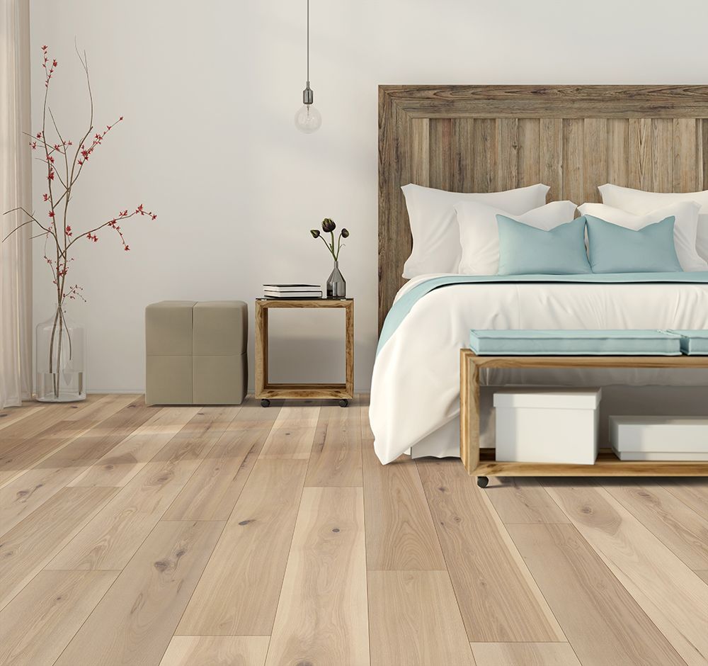 A bedroom with a bed , nightstand , and bench.