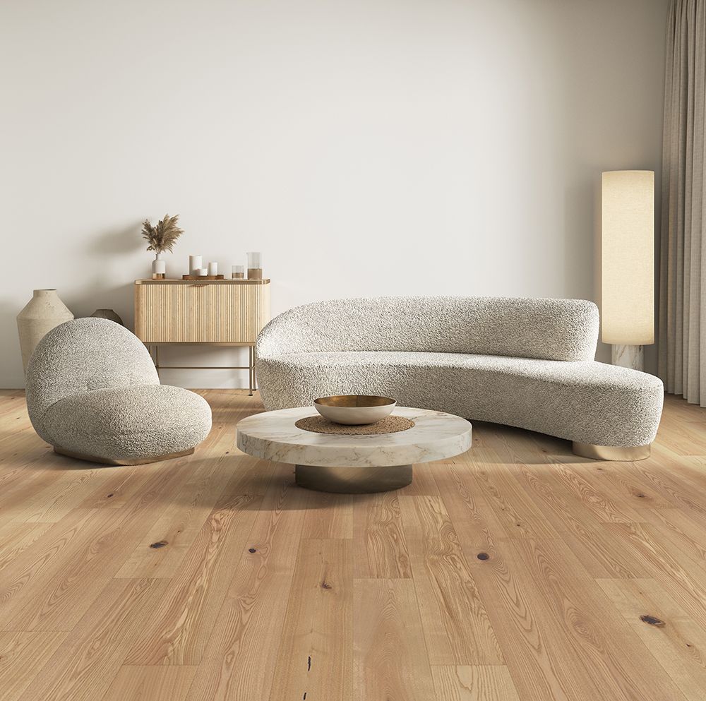 A living room with a couch , chairs , and a coffee table.