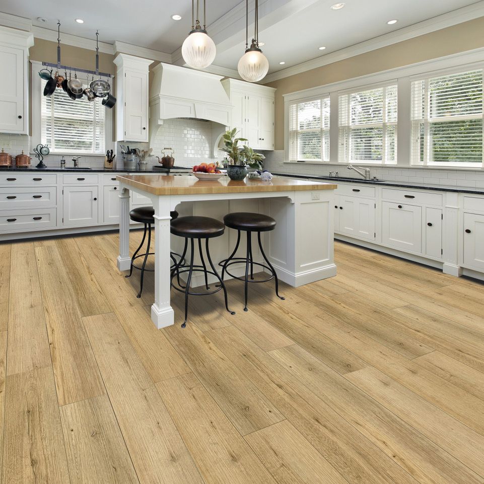 A kitchen with a large island and stools