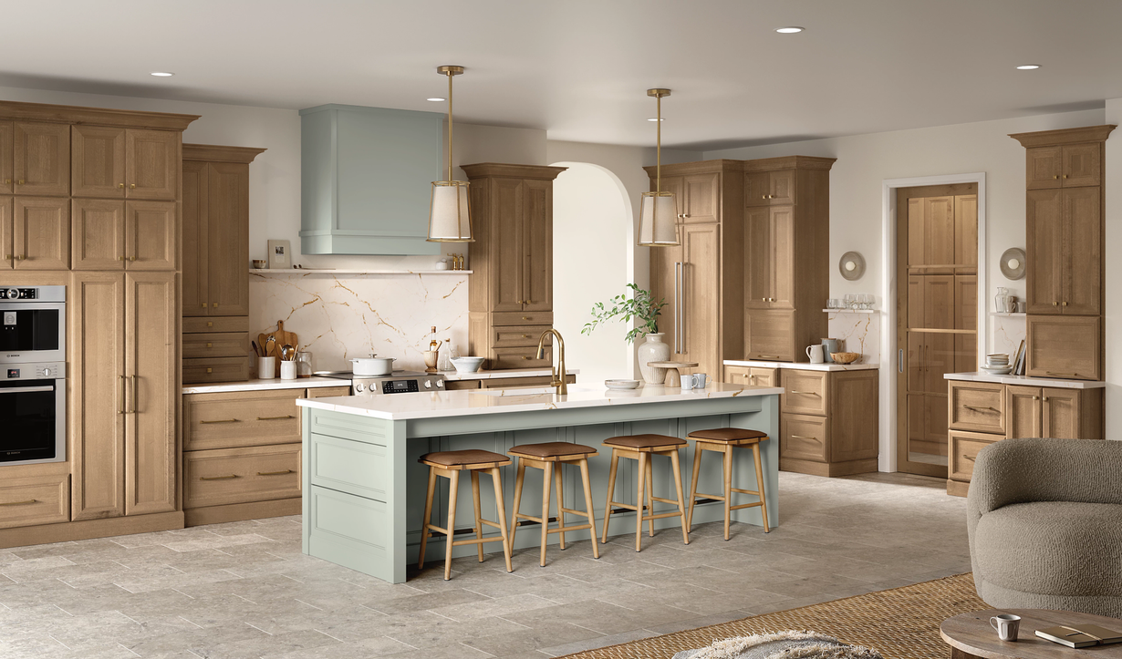 A kitchen with wooden cabinets and a large island in the middle of the room.