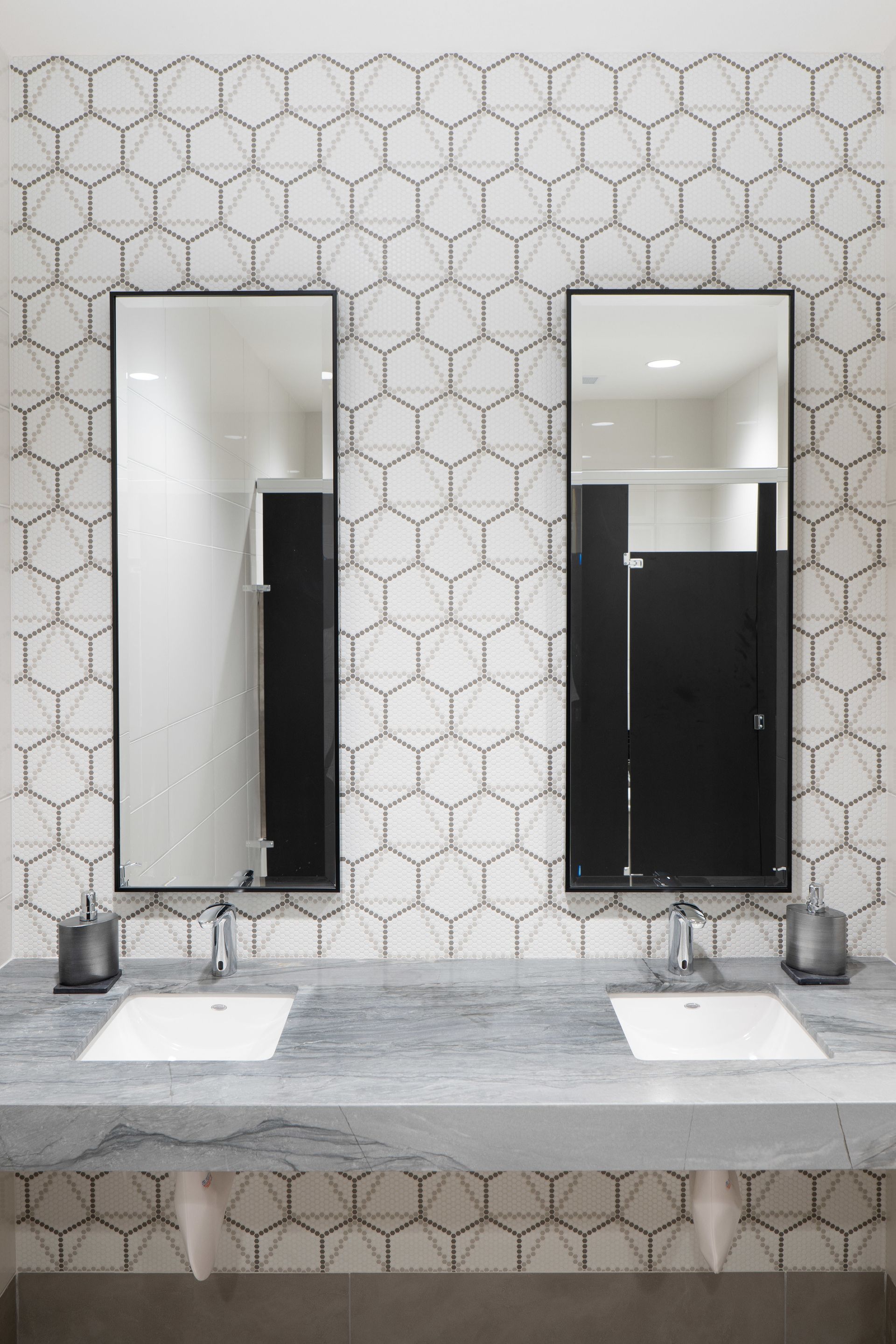 A bathroom with two sinks and two mirrors.