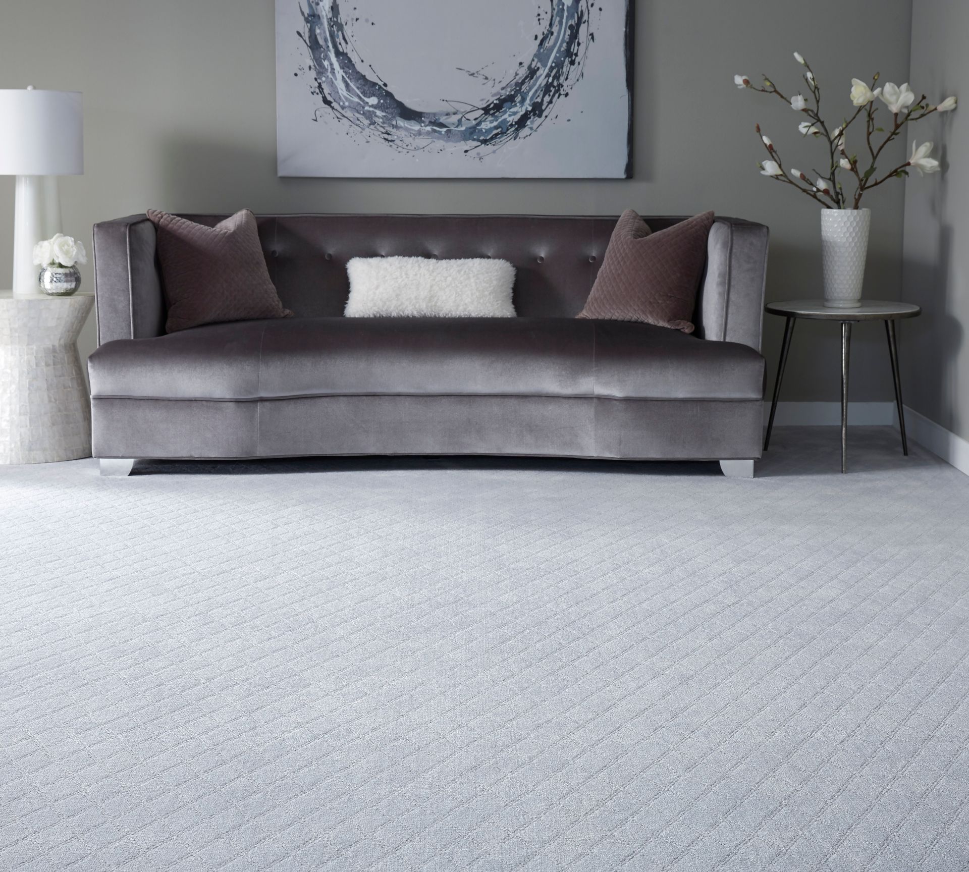 A living room with a couch and a painting on the wall