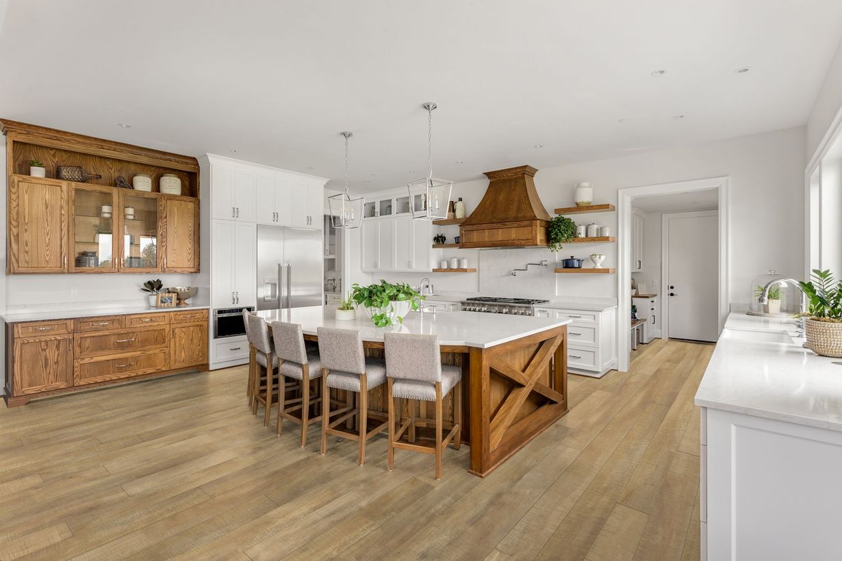 A kitchen with a large island and a dining table.