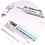 U.S. tax forms: IRS Form 1040 and U.S. Return of Partnership Income, printed on white paper.