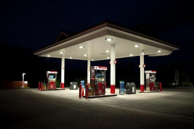 A gas station is lit up at night.