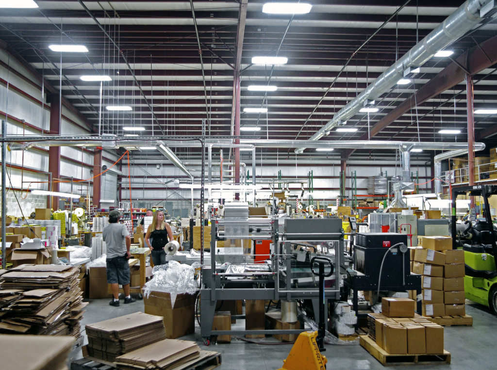 A large warehouse filled with lots of boxes and machinery.