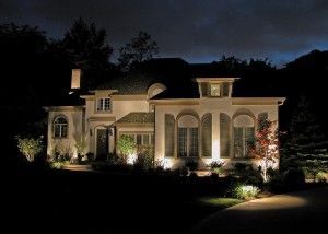 A large house is lit up at night.