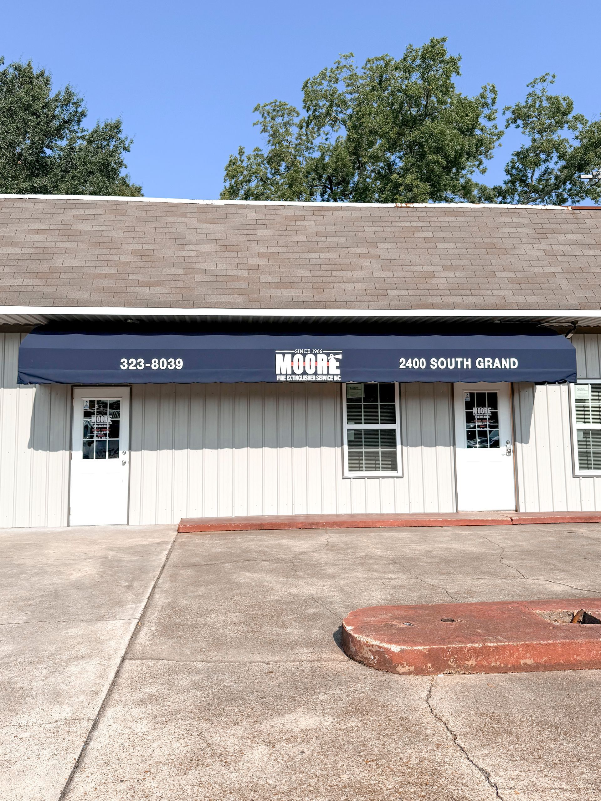 Exterior of a building with a blue awning that reads 