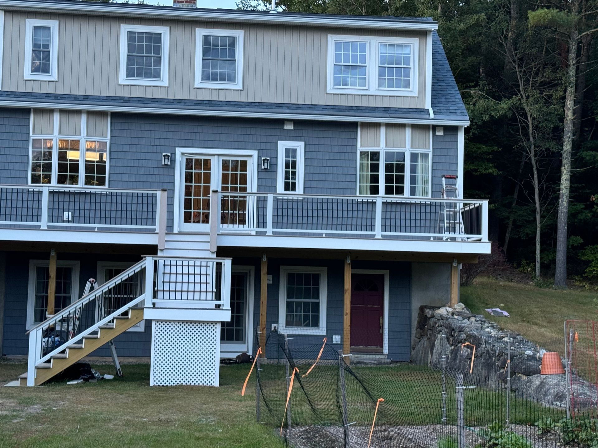 A large house with a large deck and stairs