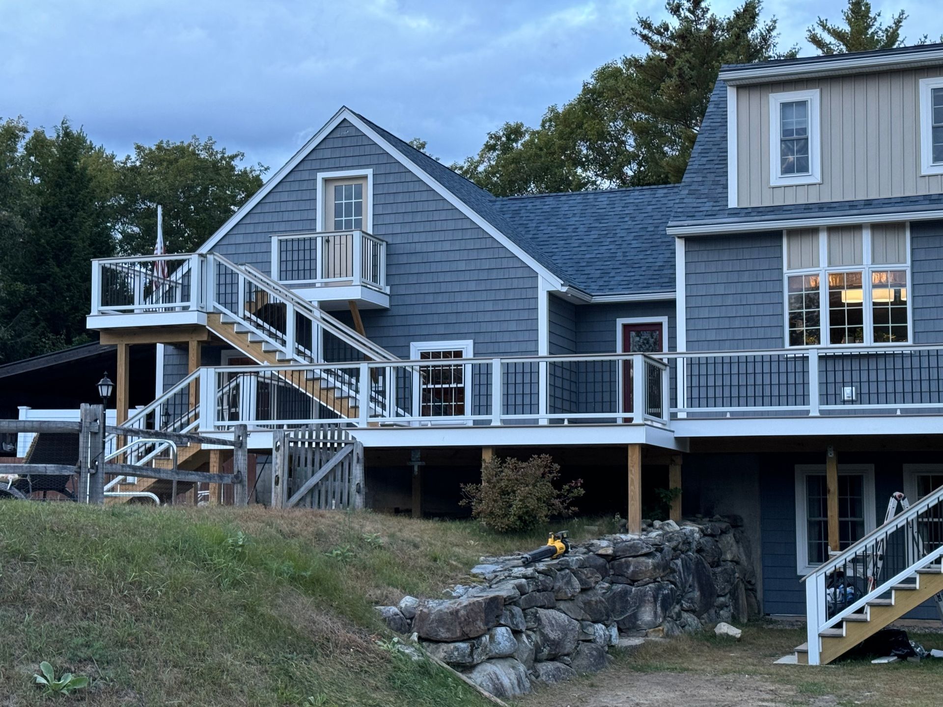 A large house with a large deck and stairs.