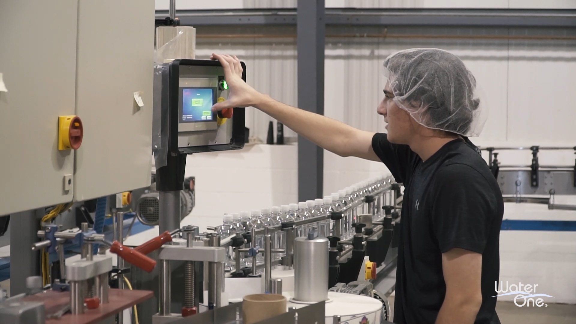 A man is working on a machine in a factory.