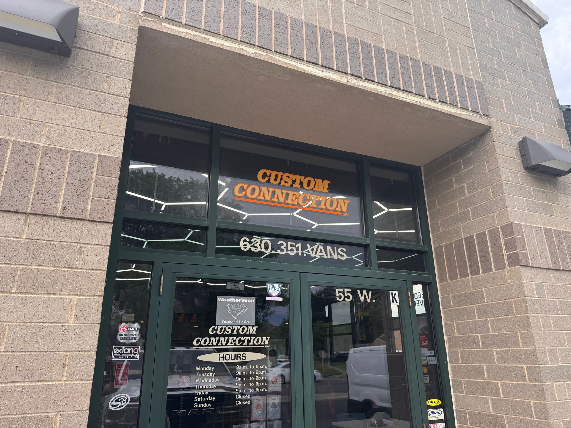 Storefront with glass doors and a “Custom Convoy” sign above the entrance.