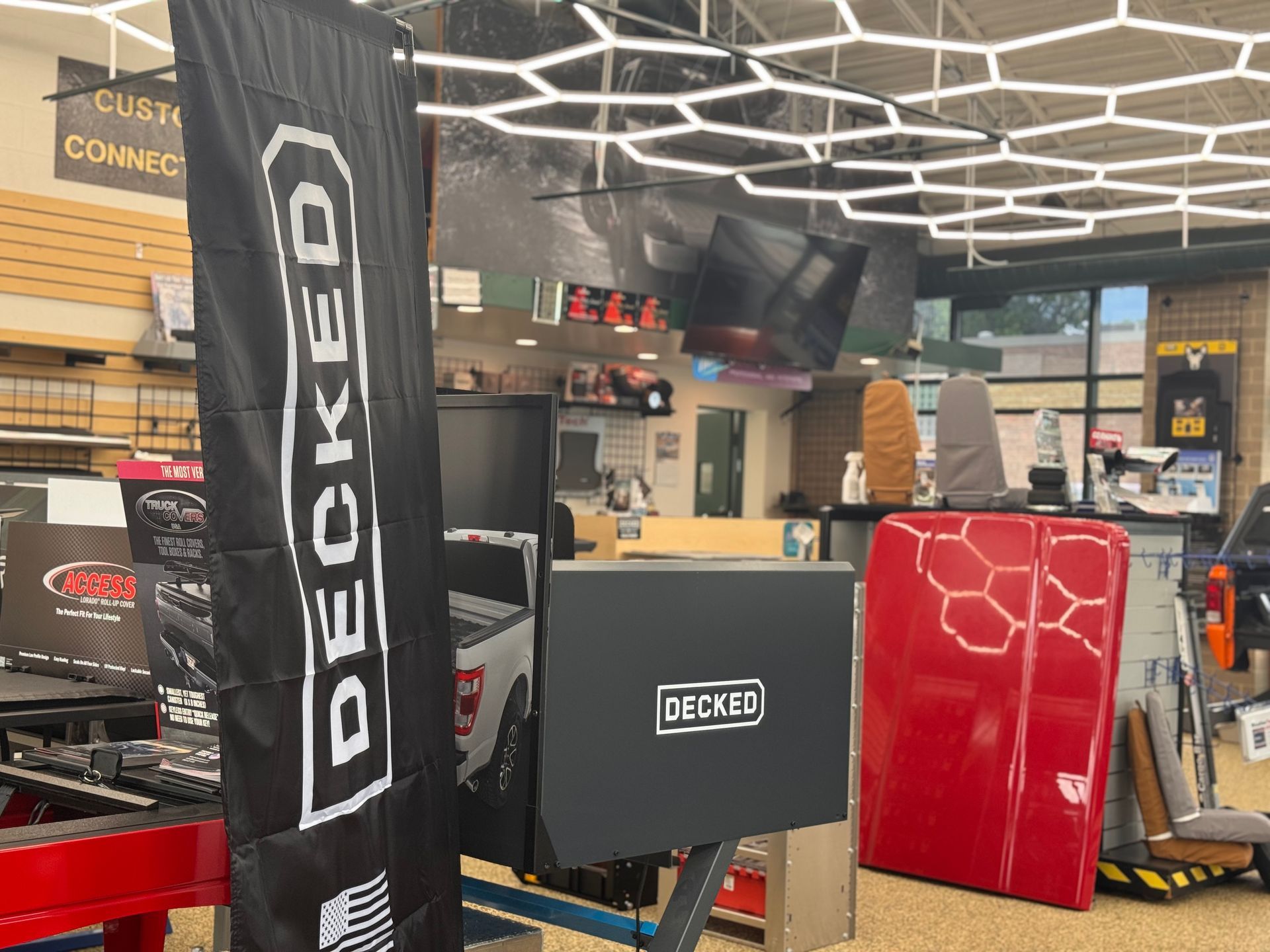 DECKED display in a retail store with black, red, and orange products and signage