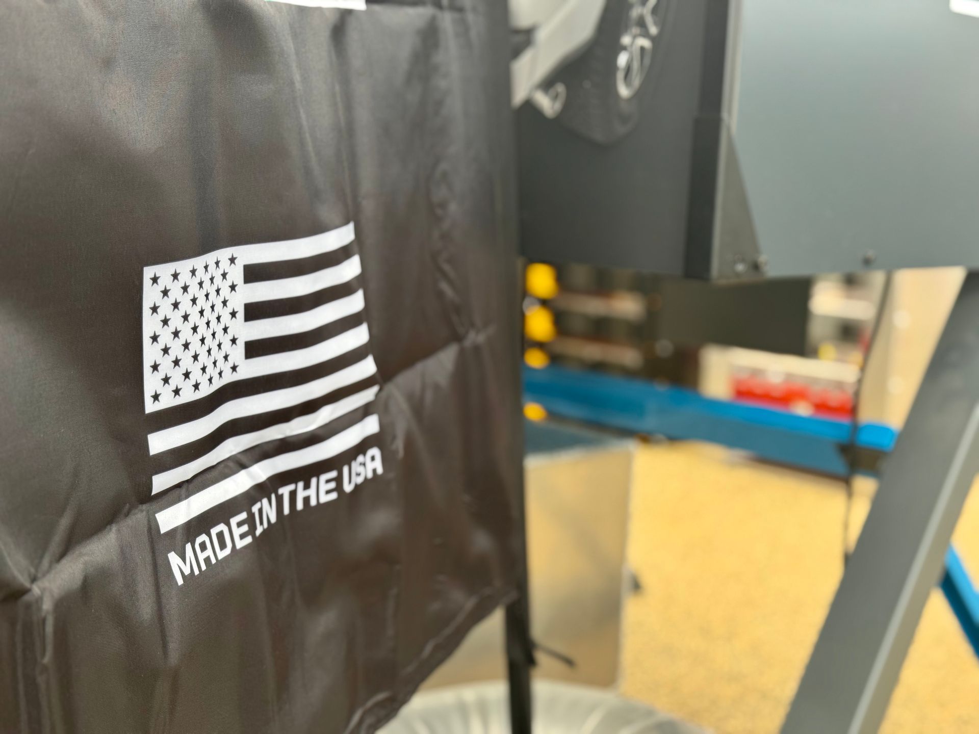Black jacket with a white American flag patch and “MADE IN THE USA” text on display.