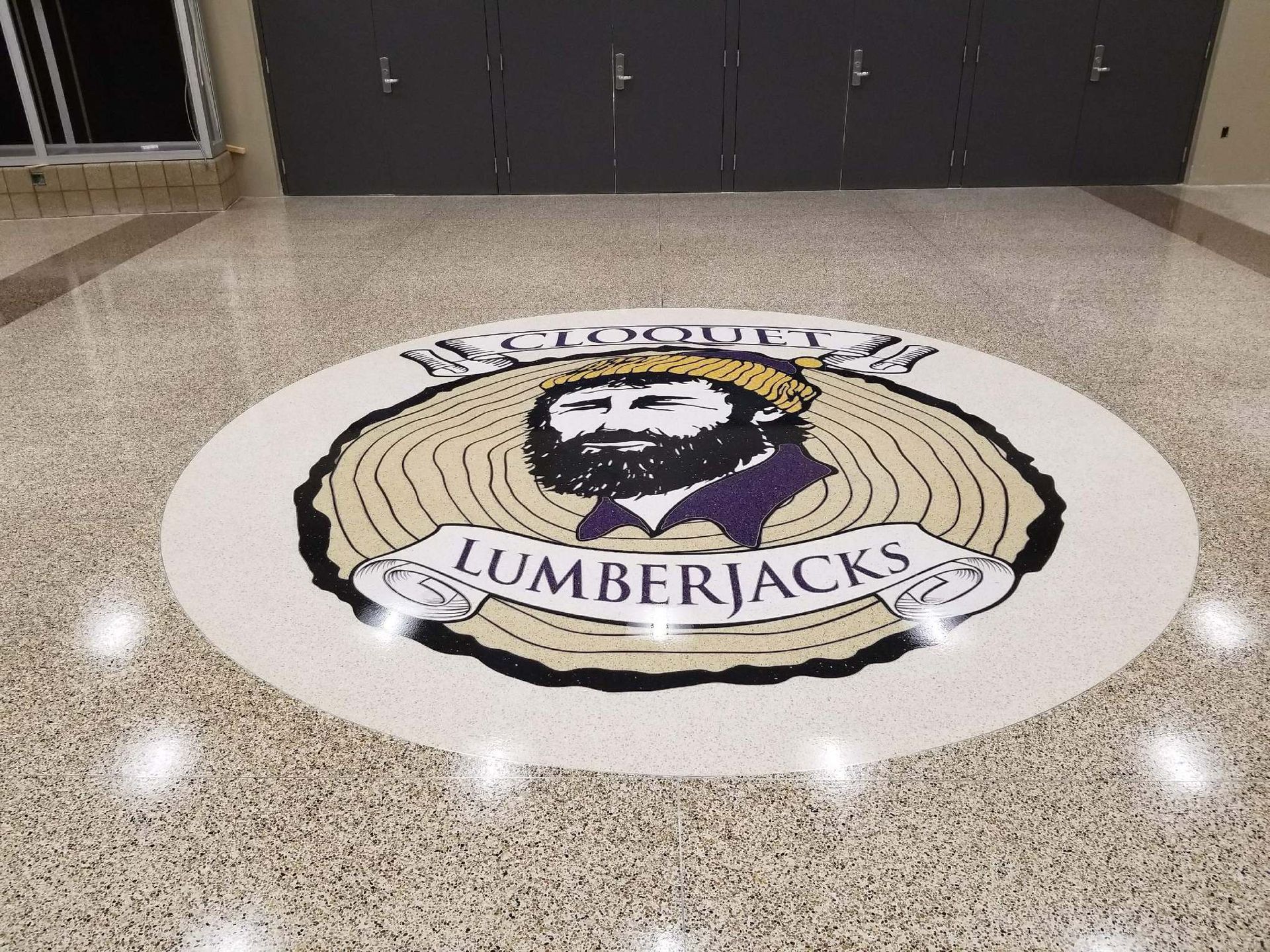 A lumberjacks logo is on the floor of a building