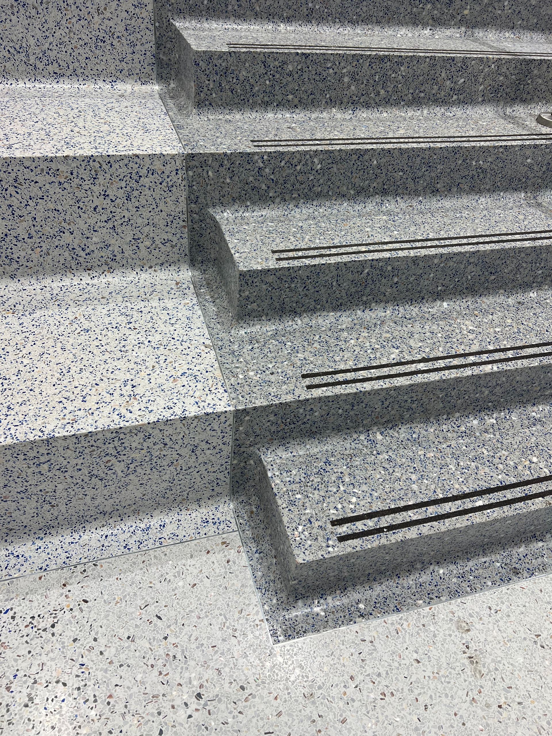 A close up of a set of stairs made of granite.