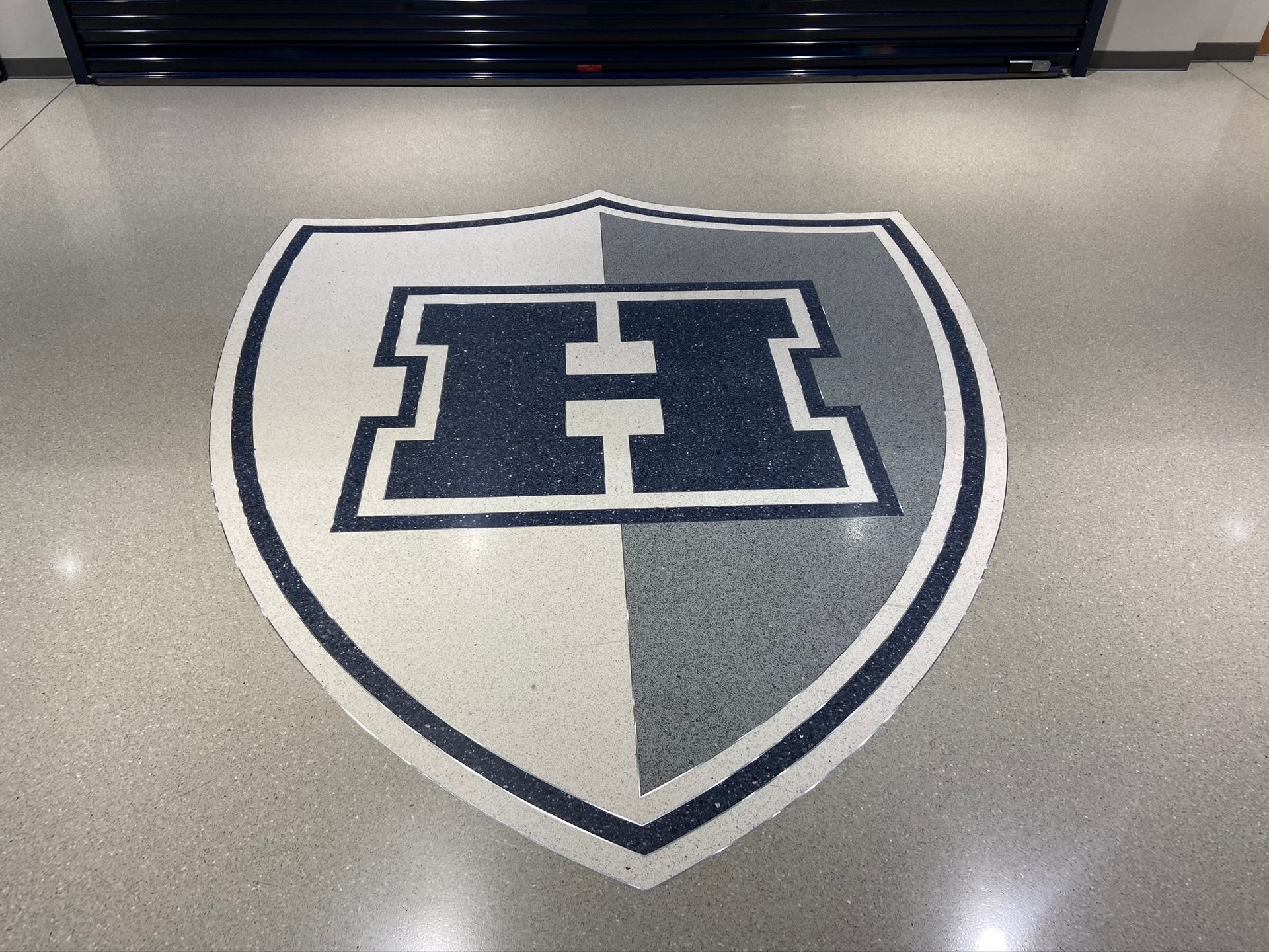A shield with the letter h on it