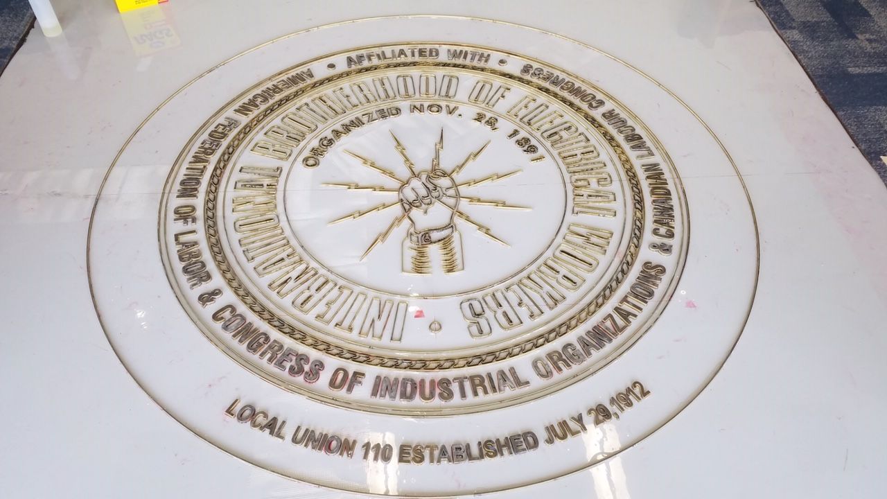 A white plate with the logo for the local union of labor and congress of industrial organizations