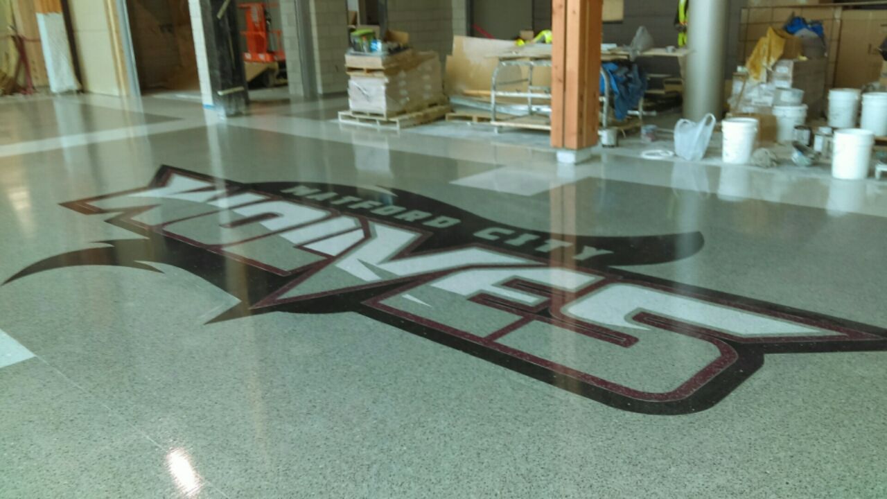 A large logo on the floor of a building.