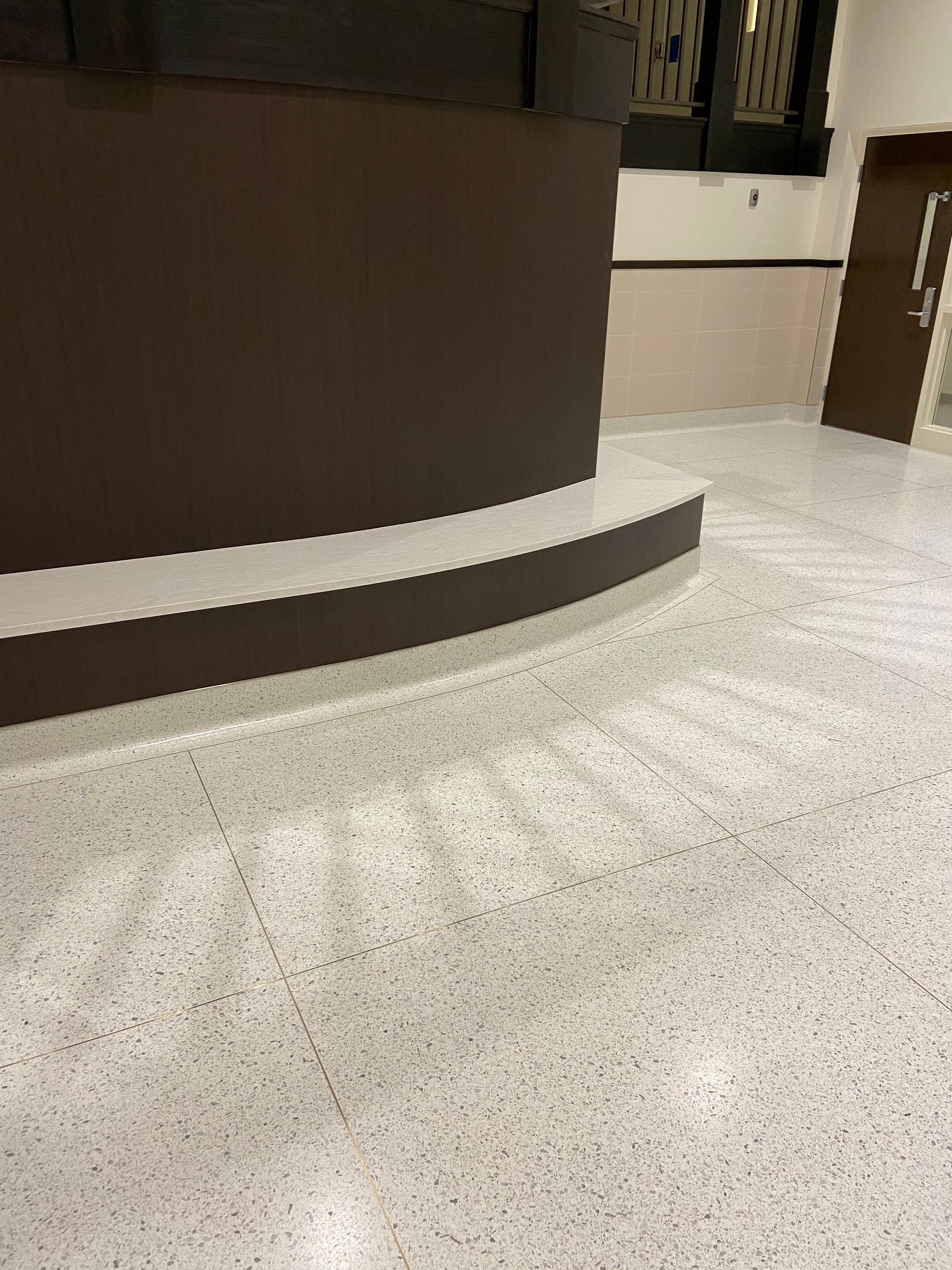 A room with a white floor and a brown wall.