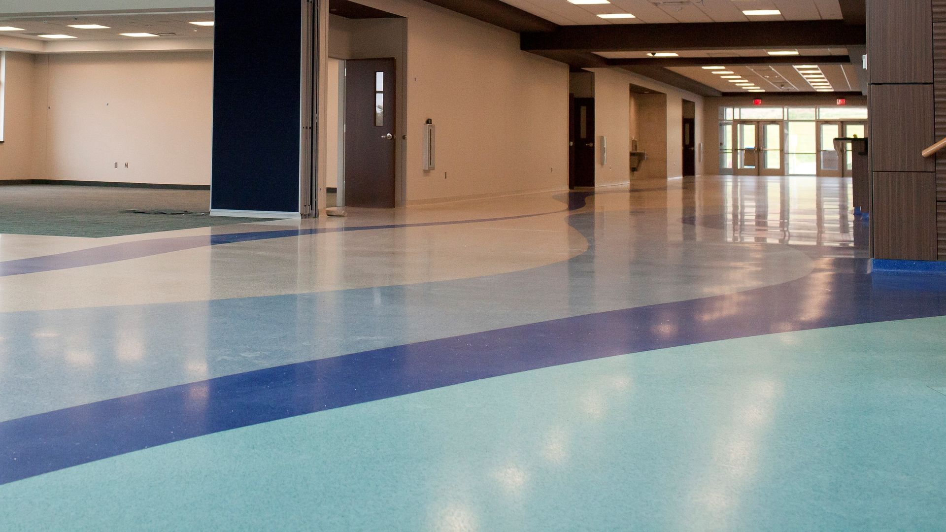 A hallway with a blue and white striped floor