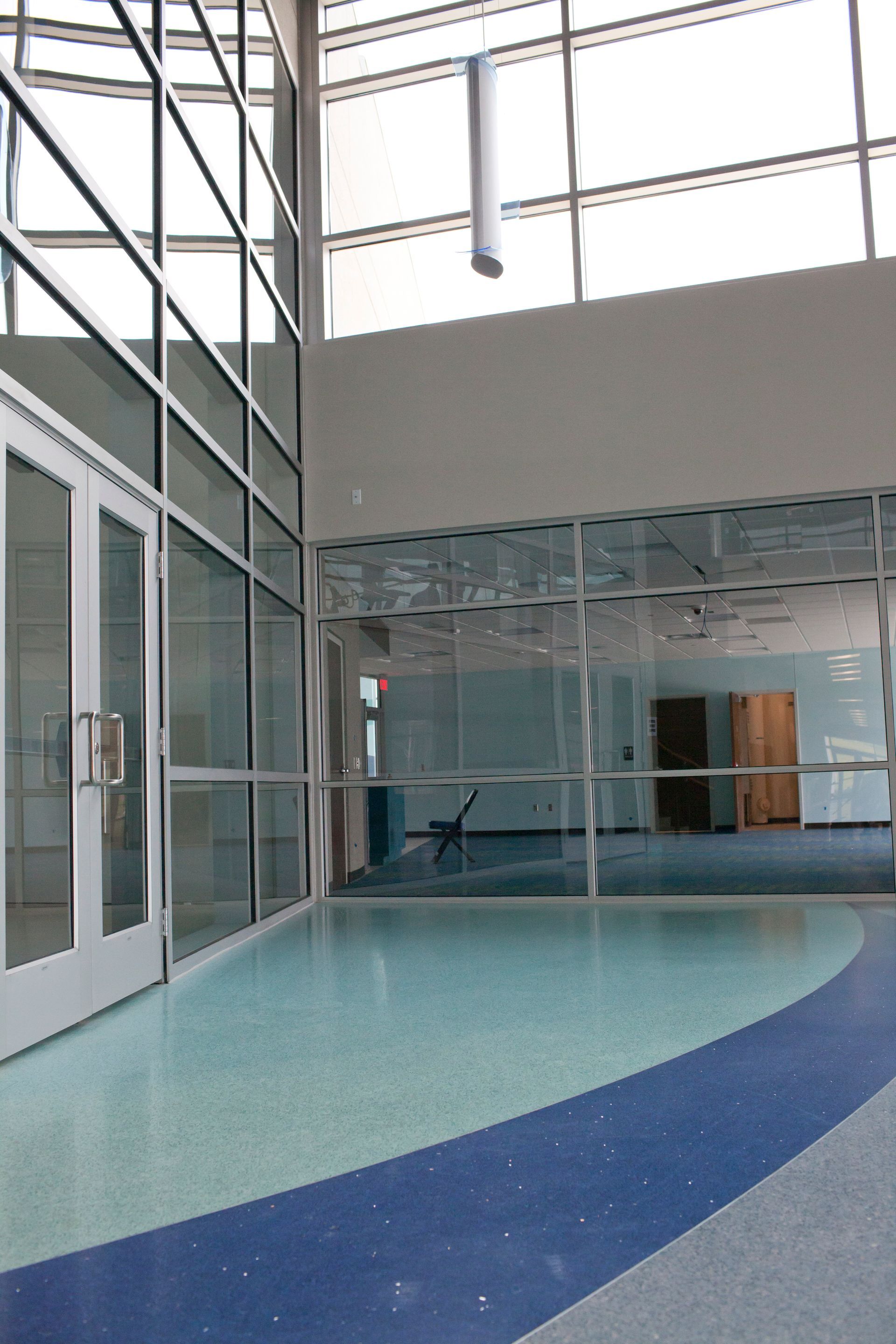 A building with a lot of windows and a blue and white floor