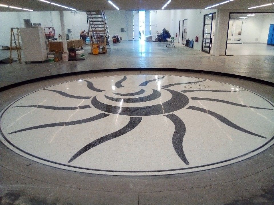 A large room with a sun design on the floor
