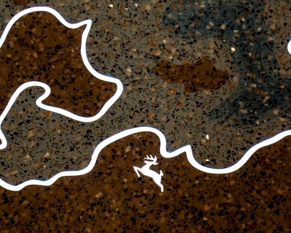 A white outline of a deer on a brown surface