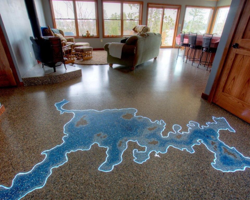 A living room with a map of a lake on the floor