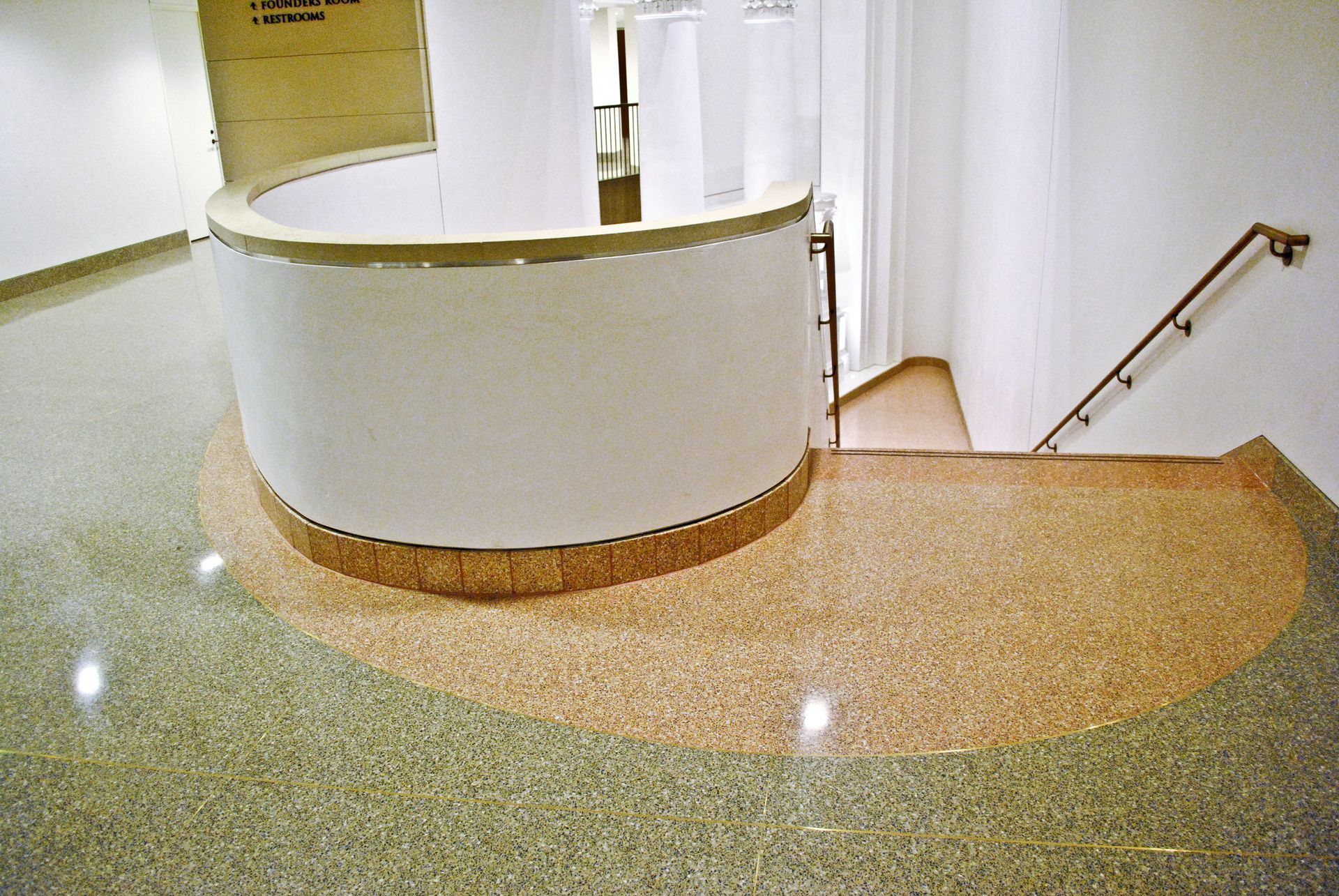 A staircase in a building with a curved wall