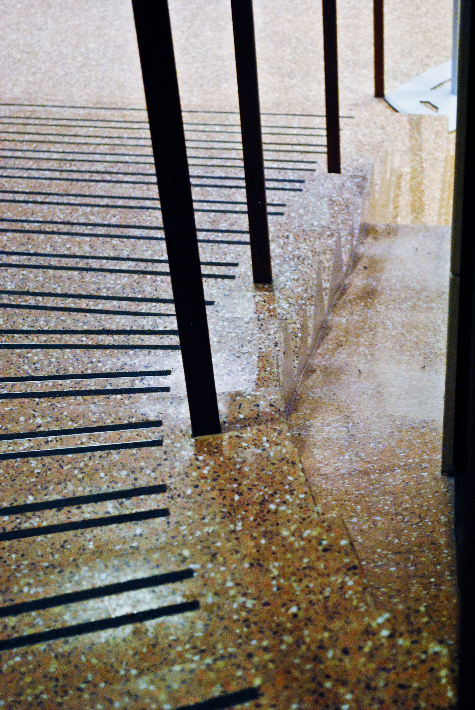 A row of stairs with black stripes on the floor