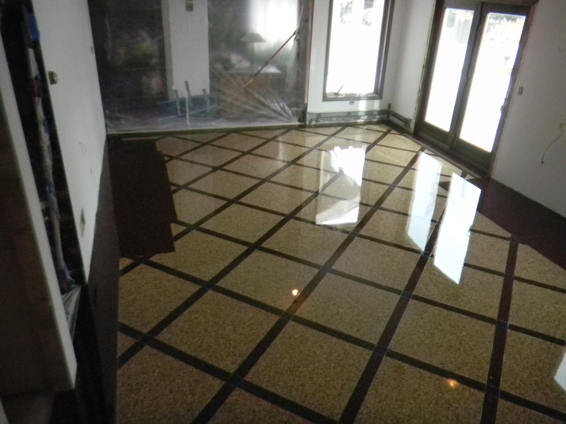 A room with a tiled floor and sliding glass doors