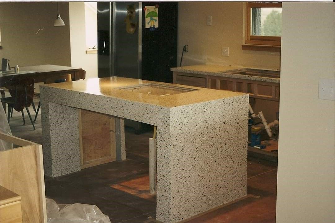 A kitchen with a large granite counter top