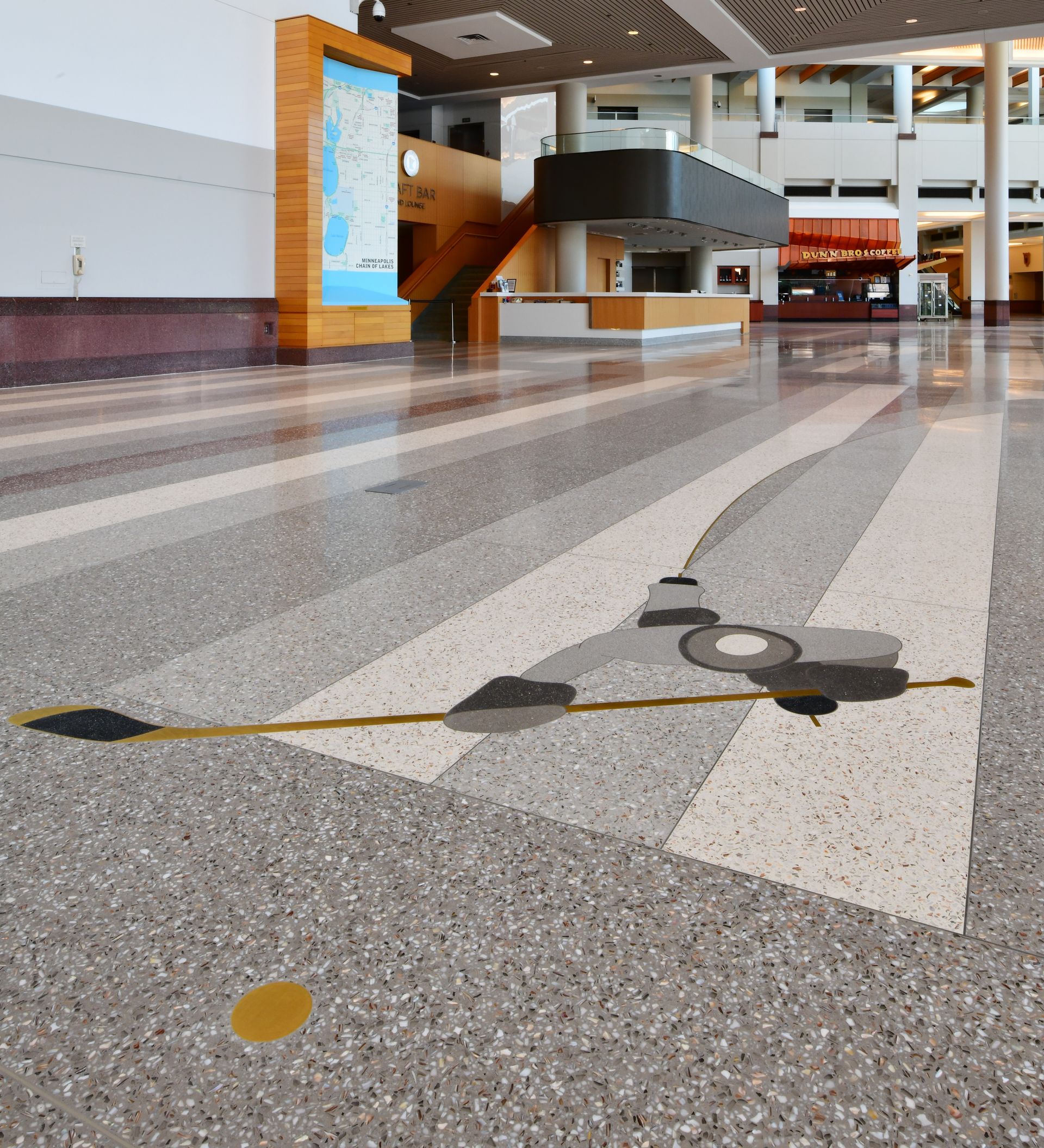 The floor of a building has a picture of a camera on it