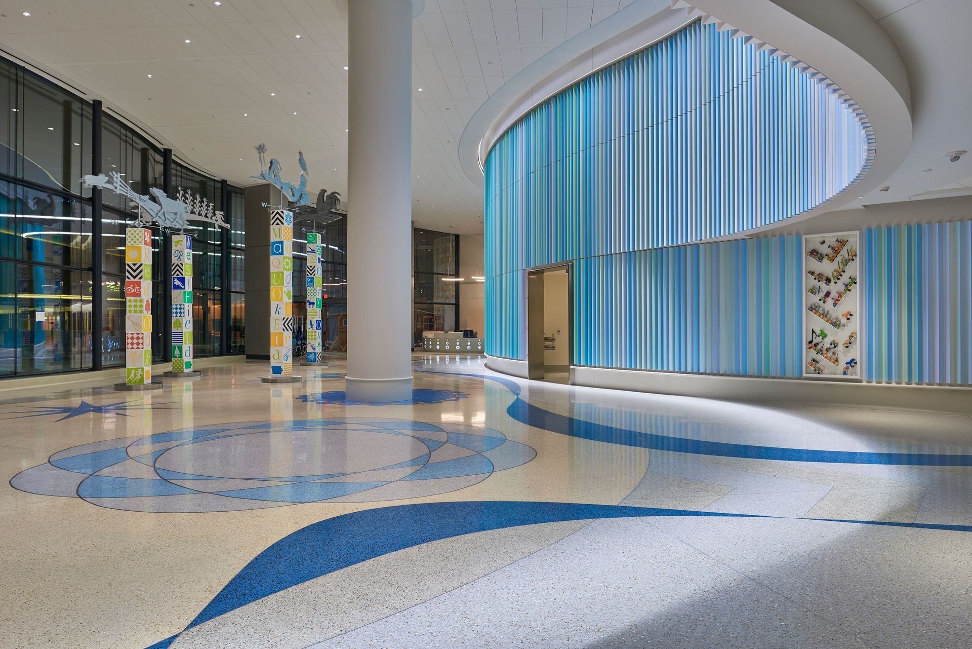 A large lobby with a circular chandelier hanging from the ceiling