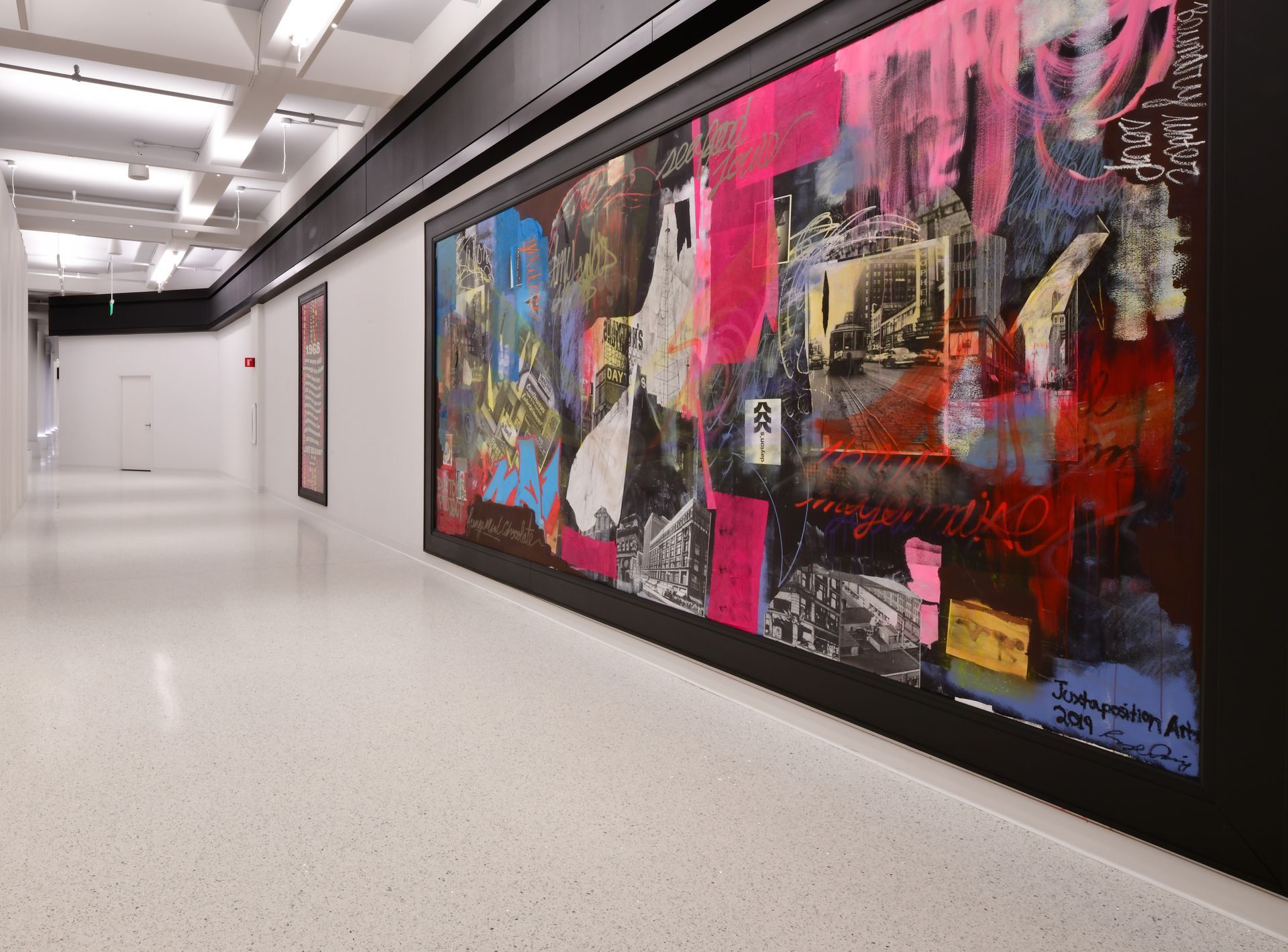 A hallway with a large painting on the wall