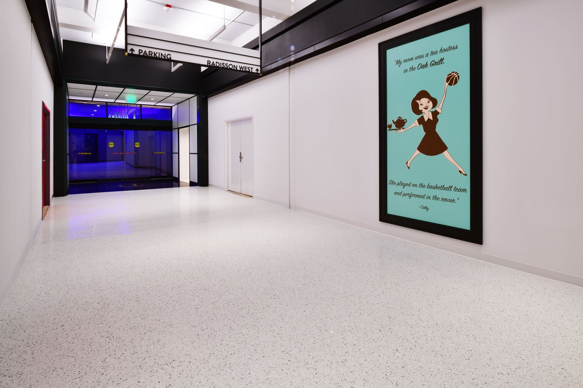 An empty hallway with a picture of a girl on the wall