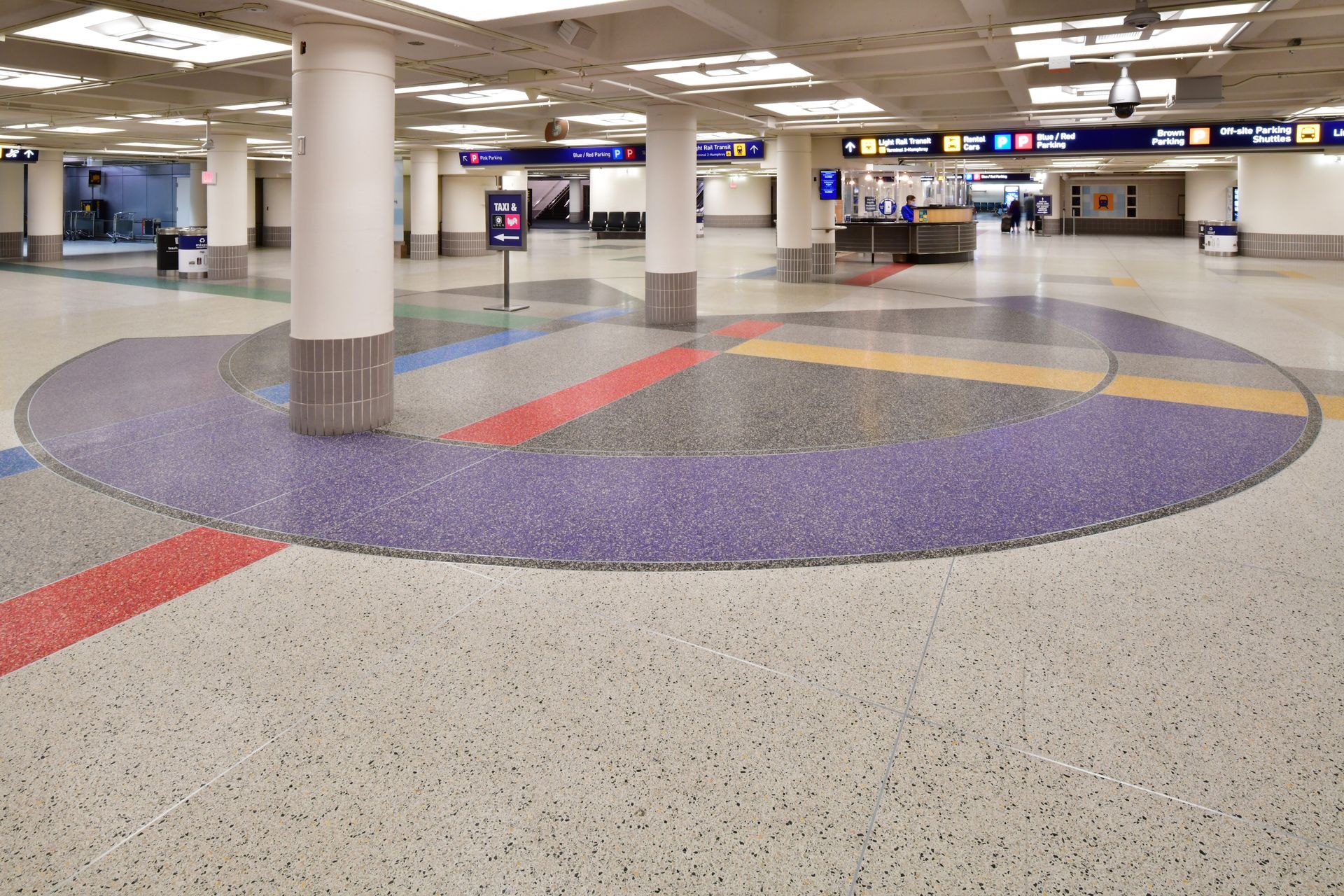 A circular area in a building with purple and red tiles