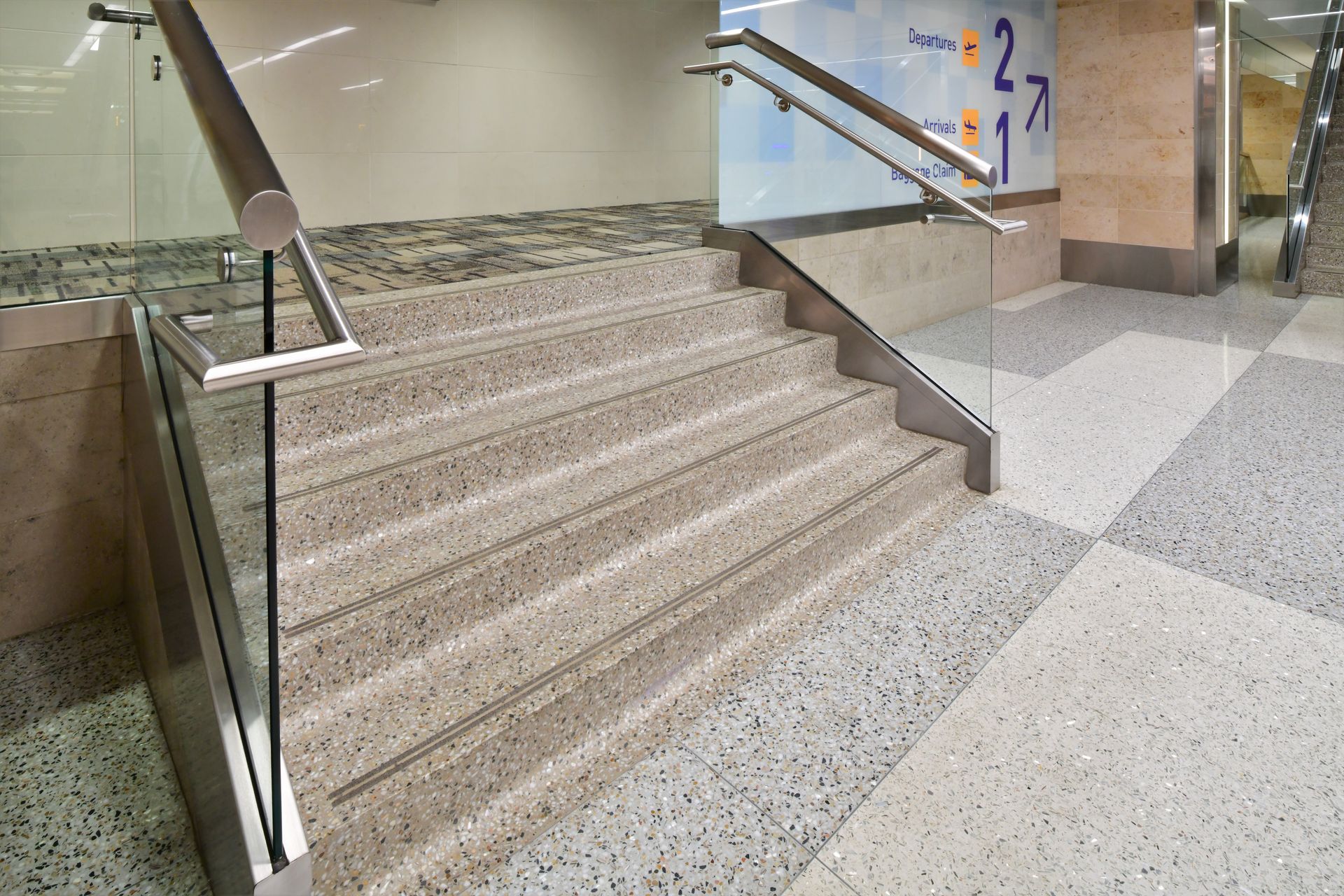 A set of stairs with a glass railing in a building