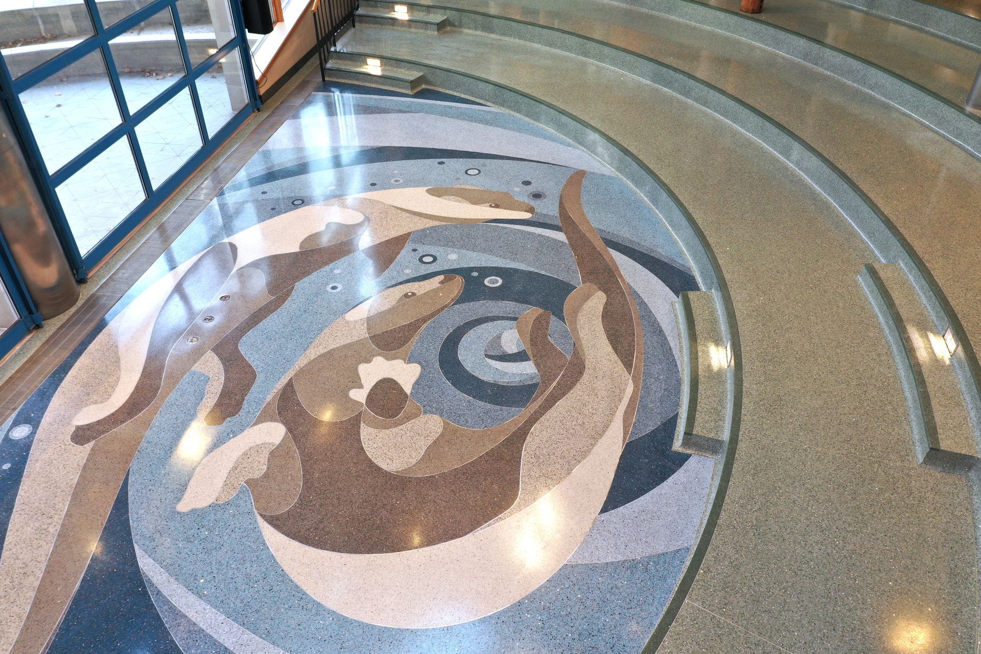 The floor of a building has a circular design on it