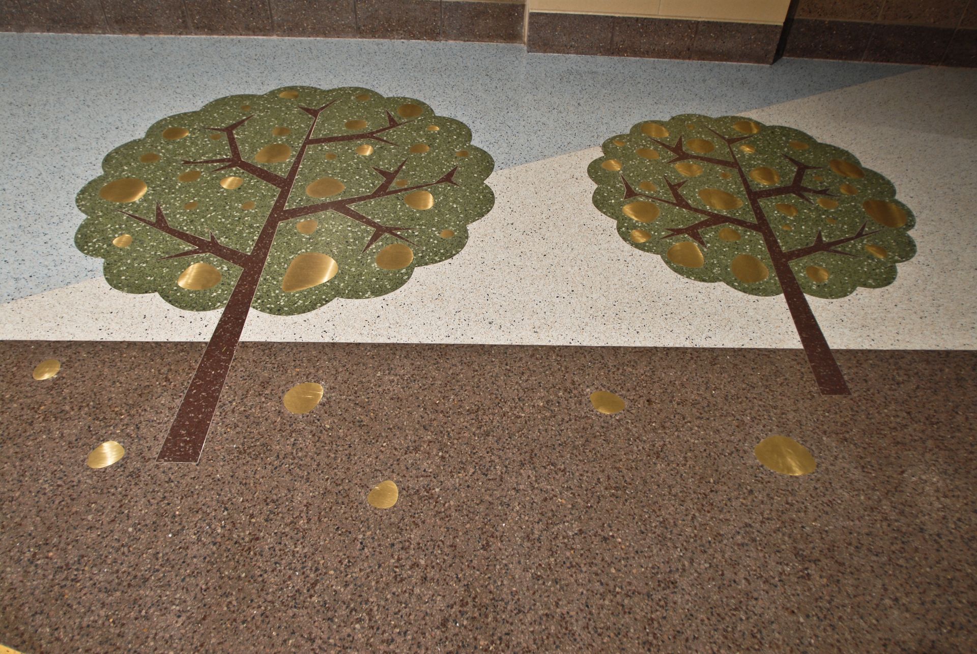 Two trees are painted on the floor of a building