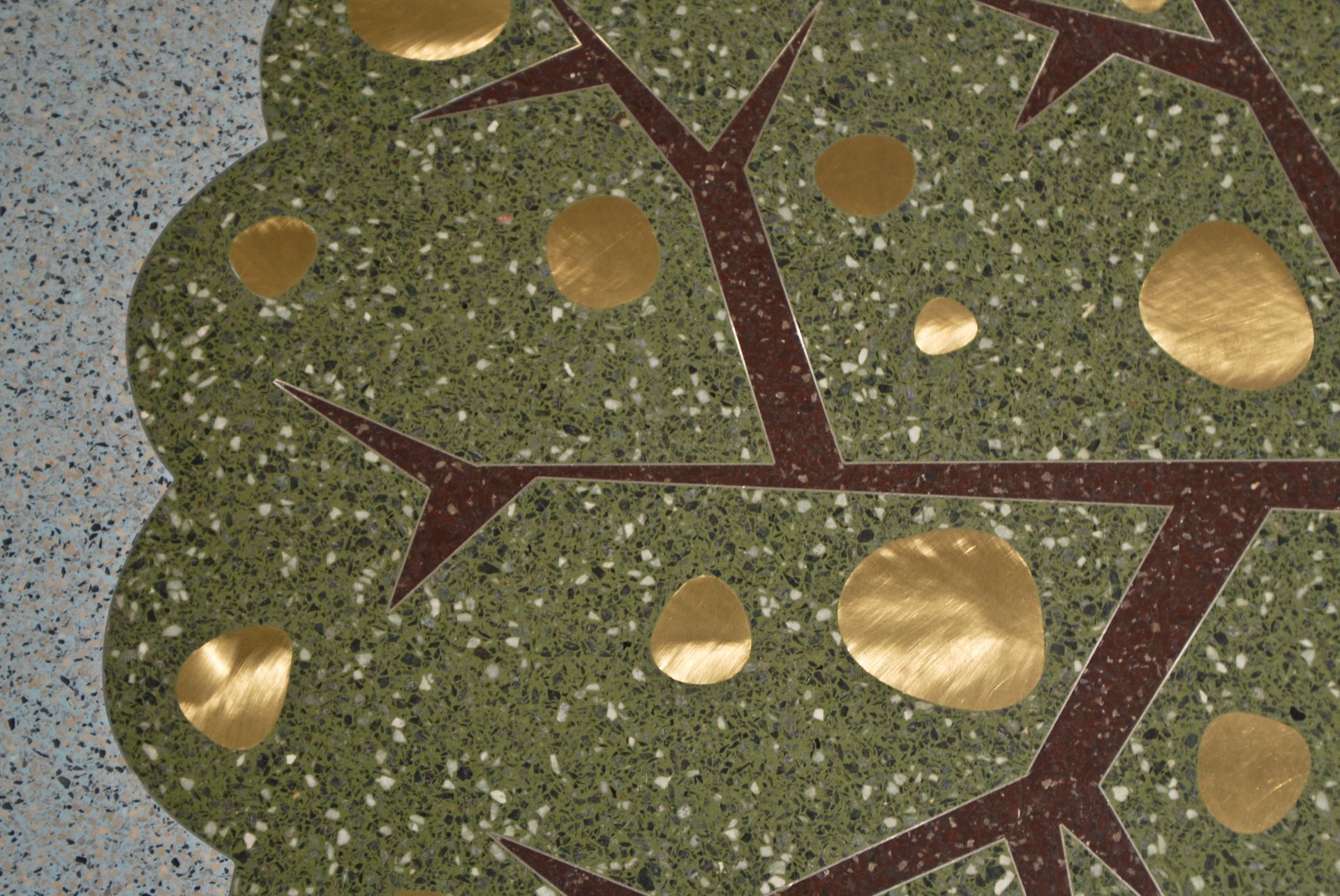 A painting of a tree with gold spots on it