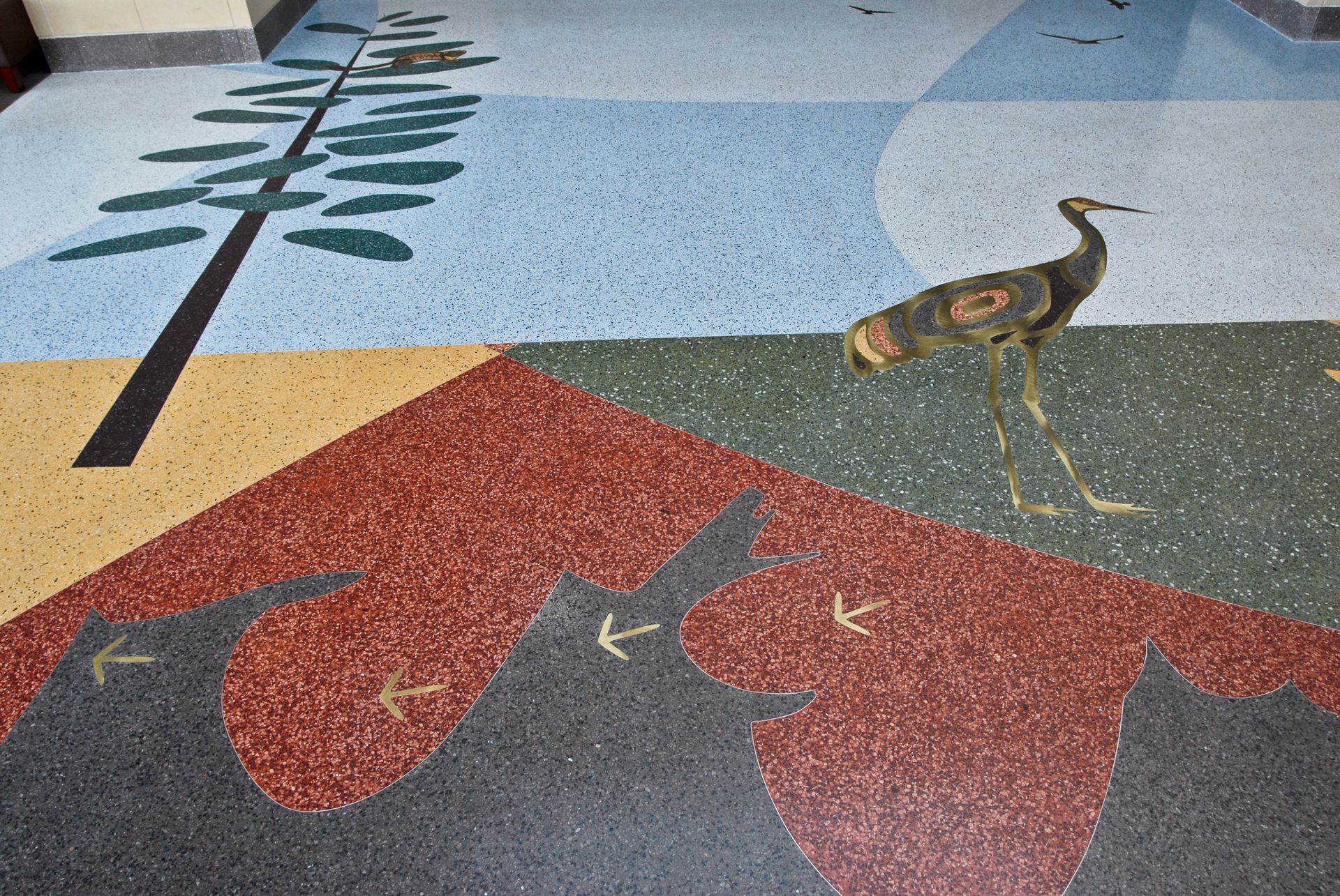 A colorful floor with a bird and a tree on it