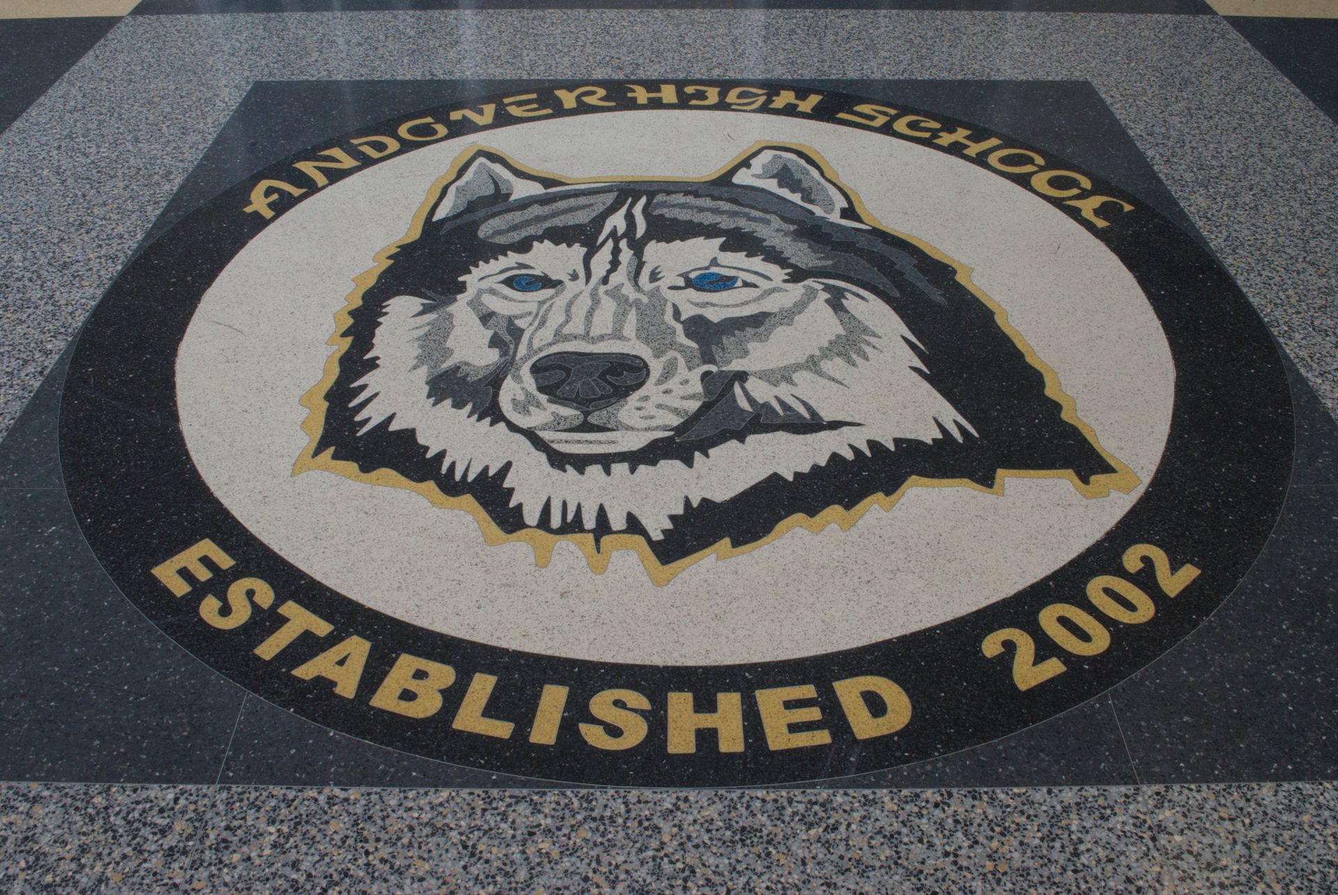 A logo for andover high school established in 2002