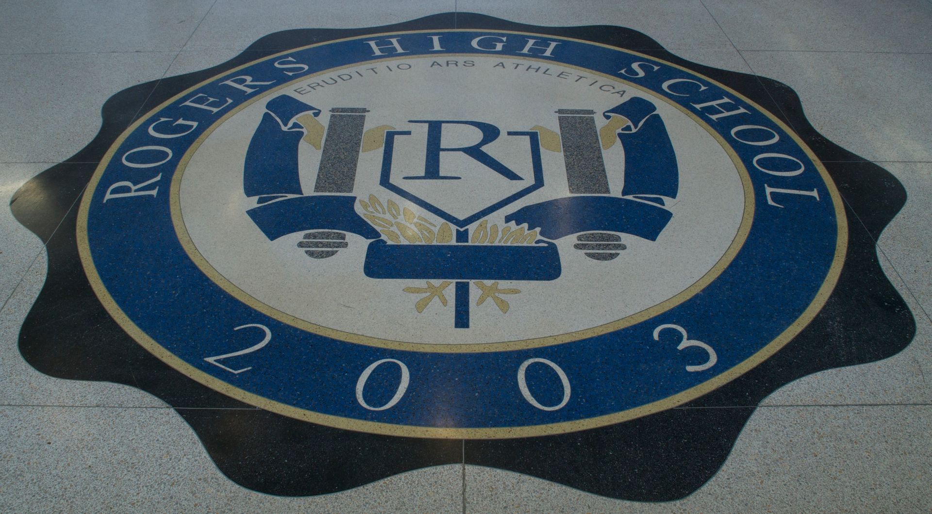 The rogers high school logo is on the floor