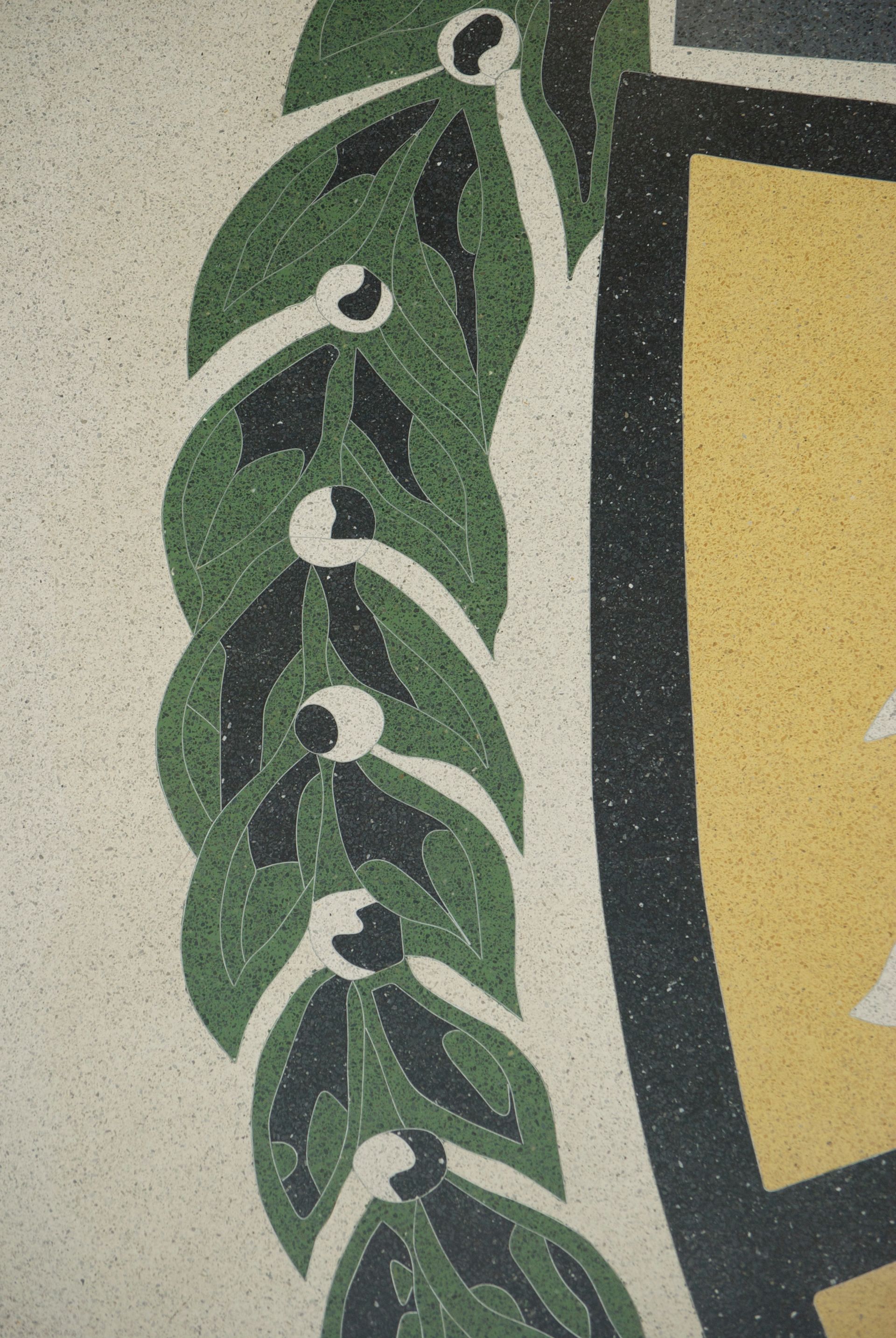 A close up of a leafy design on a wall
