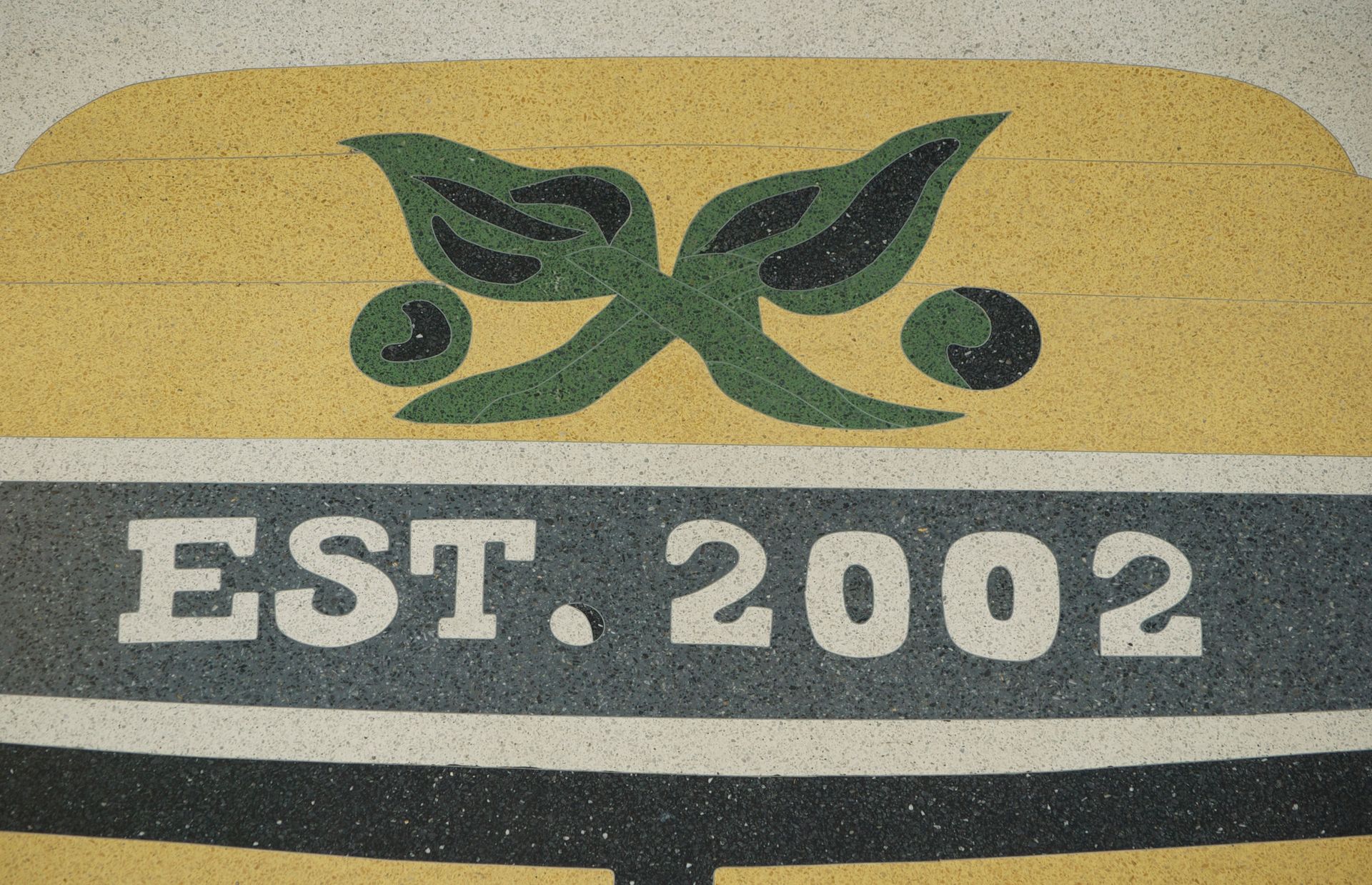 A sign that says est 2002 on it