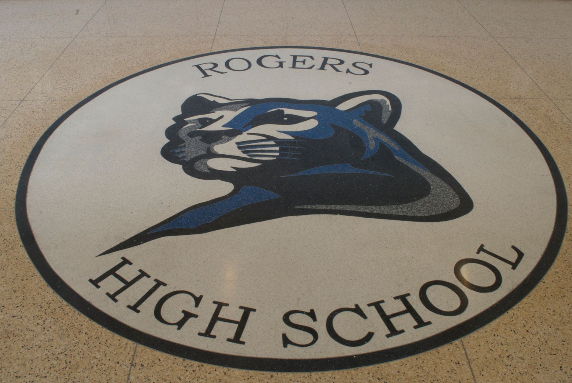 A logo for rogers high school with a panther on it